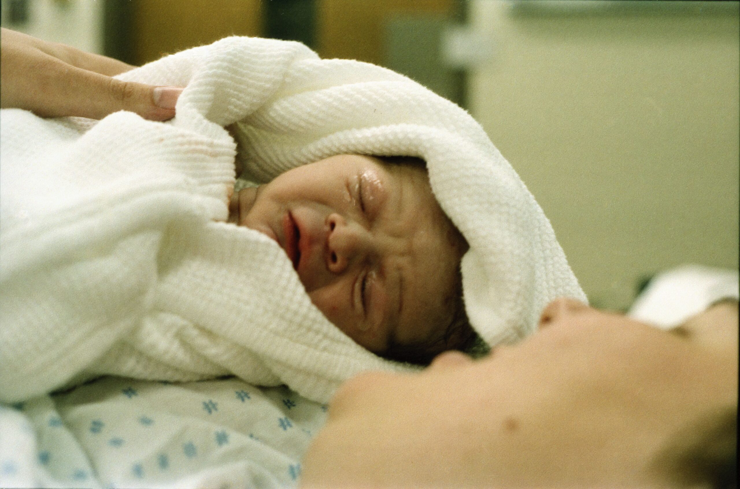 Mother holding her newborn during the golden hour after birth